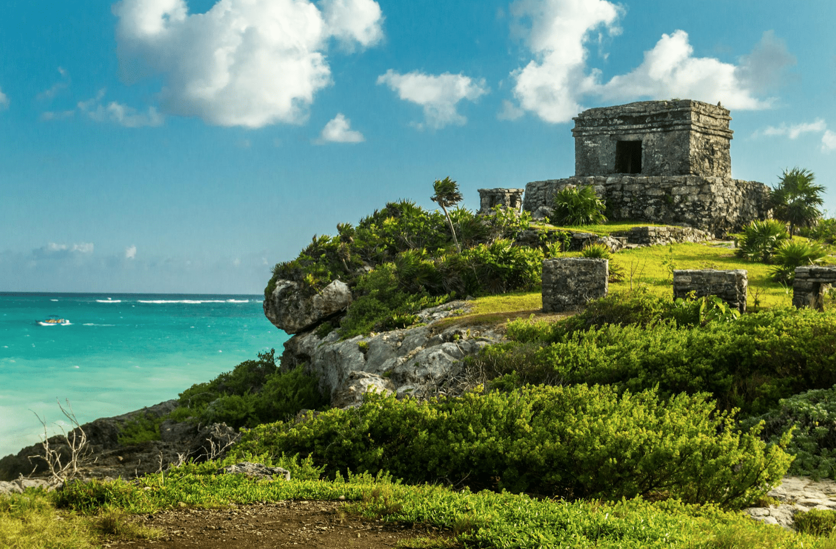 Ancient Mayan ruins overlooking the turquoise waters of the Caribbean Sea in Tulum, Mexico.